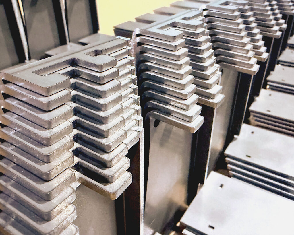 Fiber Laser cut low carbon steel parts formed and stacked