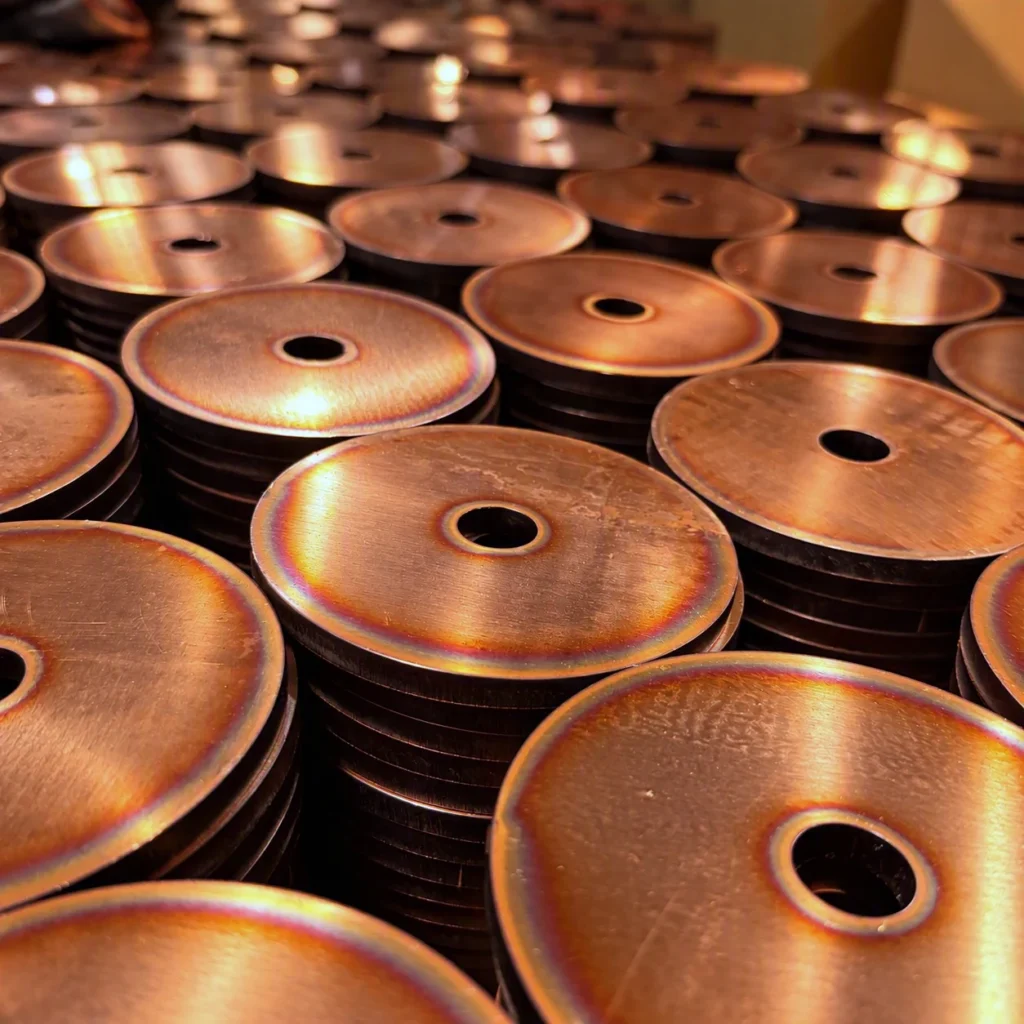fiber laser cut copper discs stacked up
